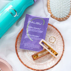 lifestyle image of Malibu Blondes Remedy sachet and hair accessories