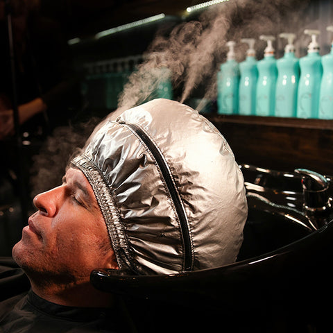 Male client at the shampoo bowl getting a spa mist service done.