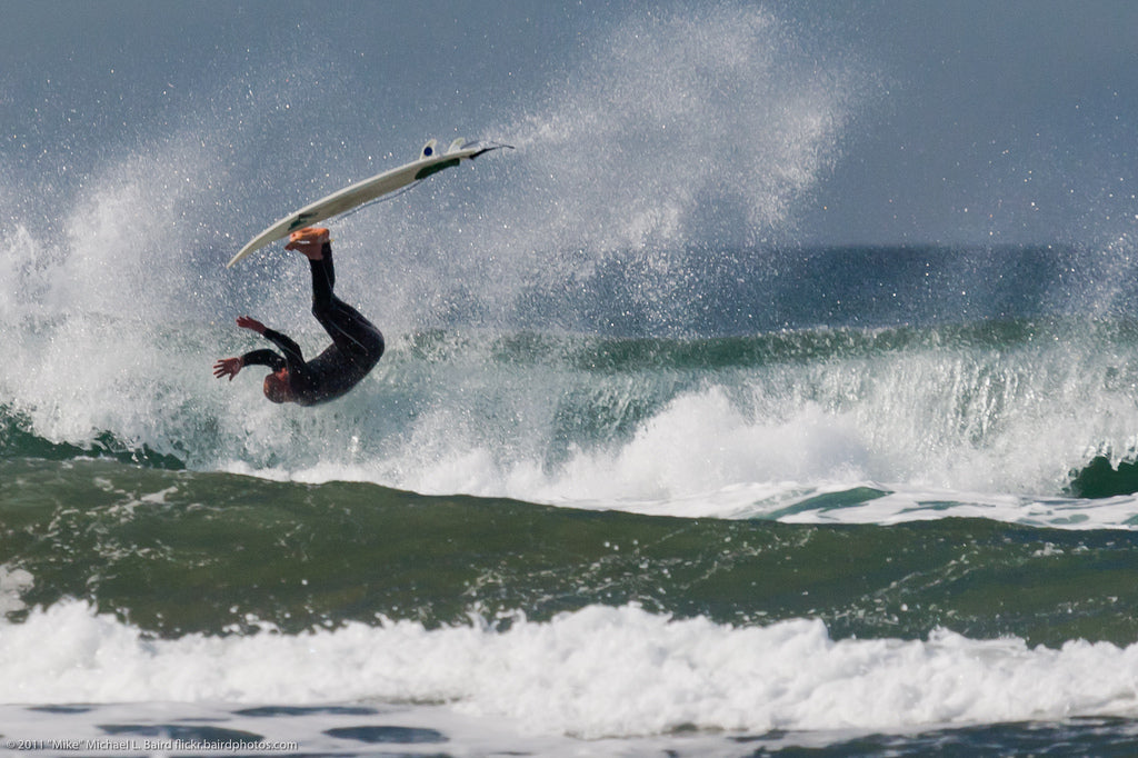 Surfer flipping on a top turn