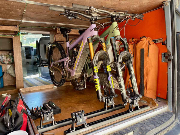 Two mountain bikes inside adventure van