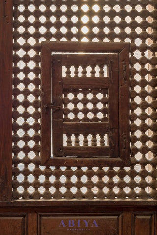 Mashrabiya Pattern-The Maymoni as seen in a wooden latticed window with two small swinging sashes in Cairo, Egypt.