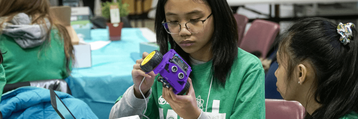 STEM student assembling robotics kit