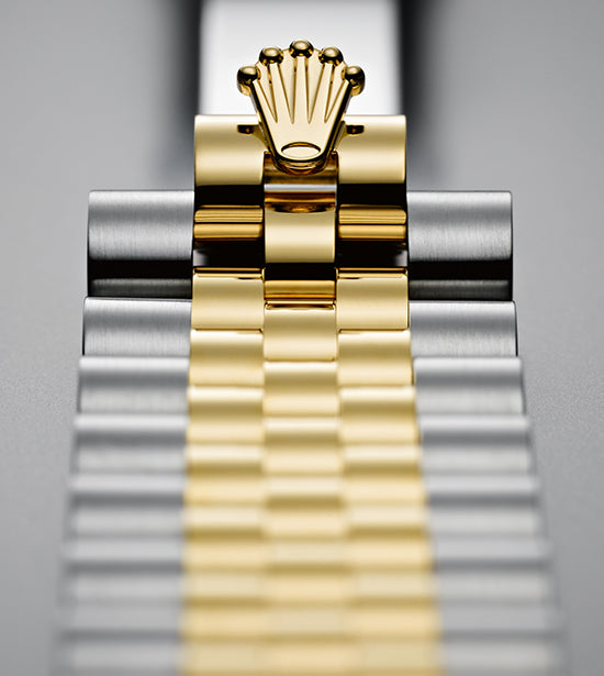 close up of a silver and gold Rolex watch strap