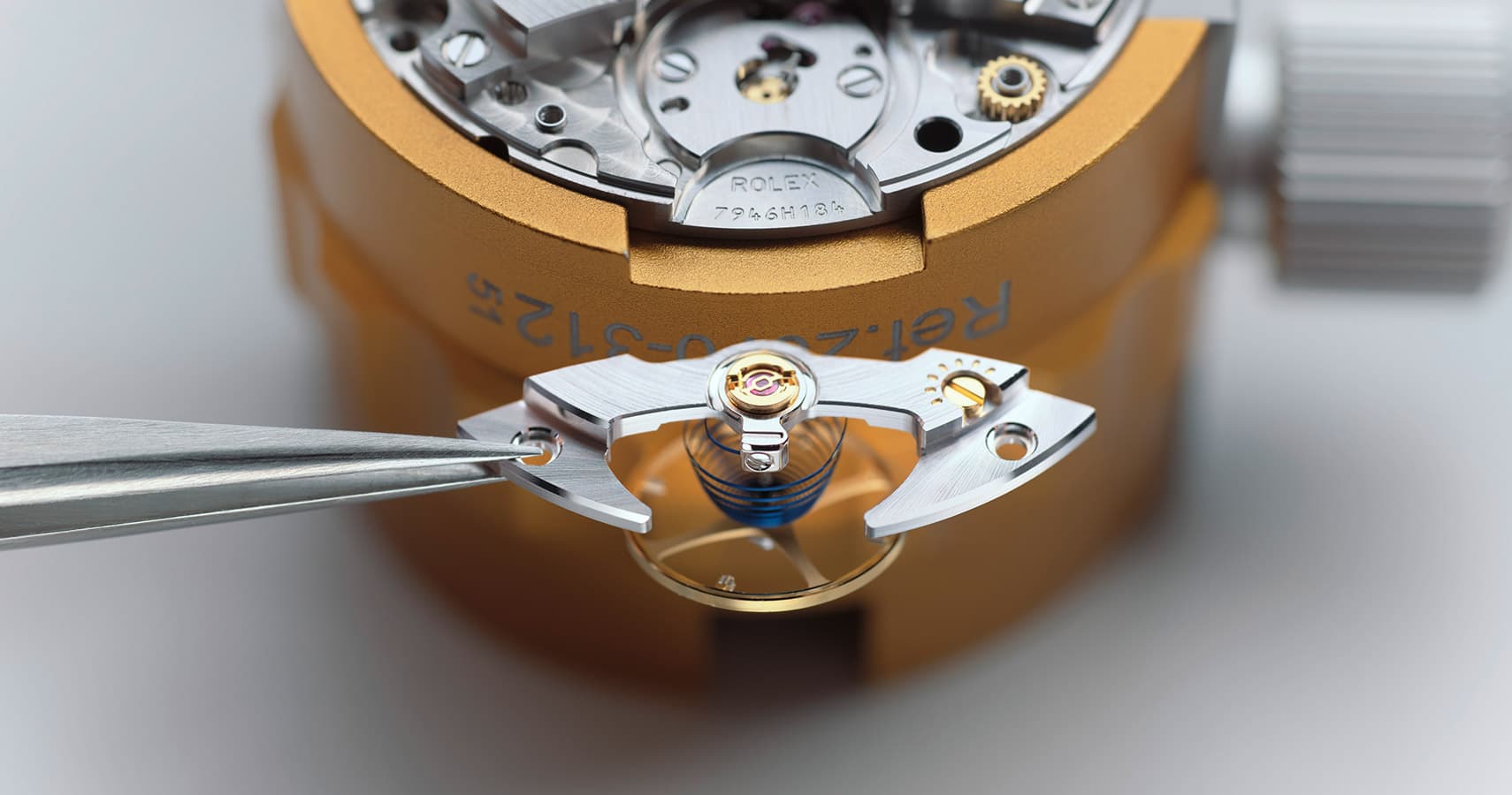 watch being carefully reassembled by a watchmaker