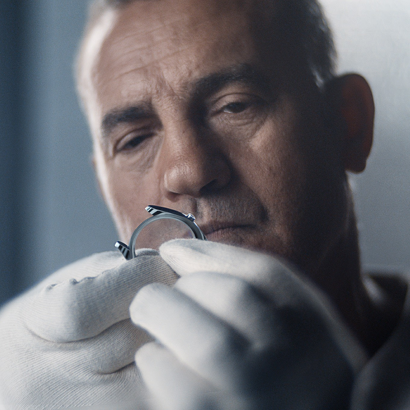 close up of person inspecting a Rolex watch