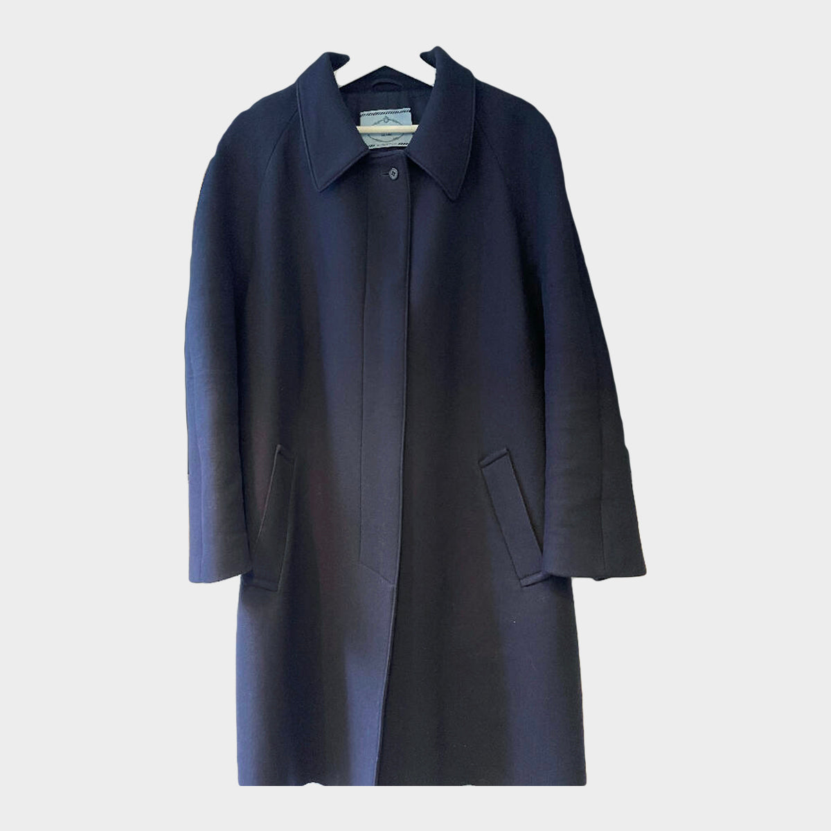 image of Prada women's navy wool coat with logo in mint fur trim at the back