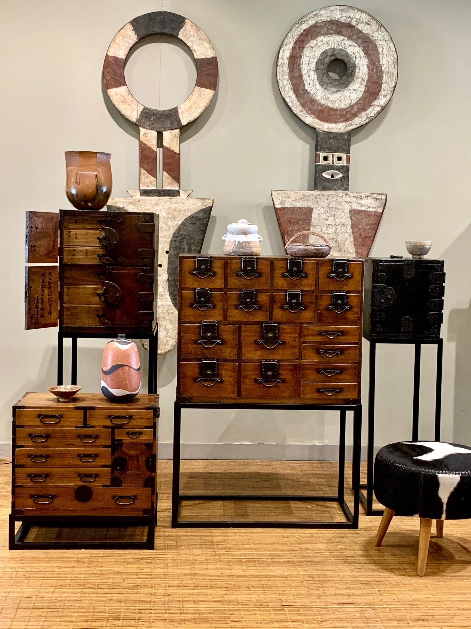 Japanese chests on stands with African masks