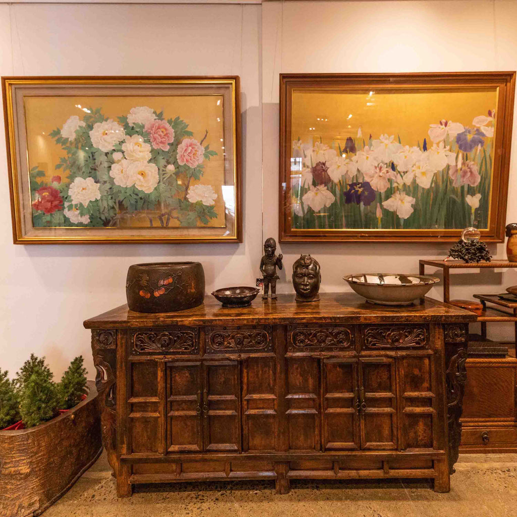 Japanese painting of peonies and irises above a Chinese hand carved sideboard.  
