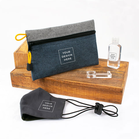 A flat lay showing a customizable care kit consisting of a zip pouch, face mask, sanitizer and an acrylic no-touch tool  