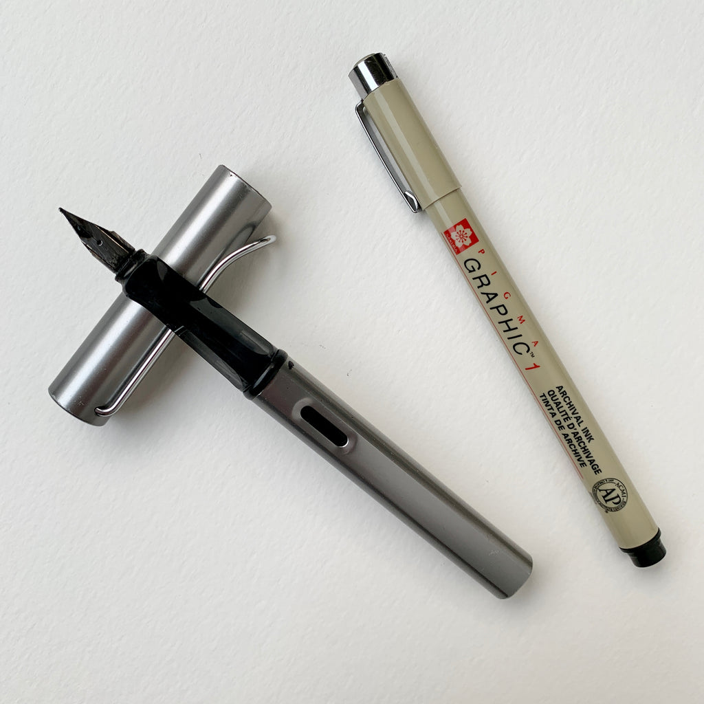 Flatlay image of a fountain pen and black marker