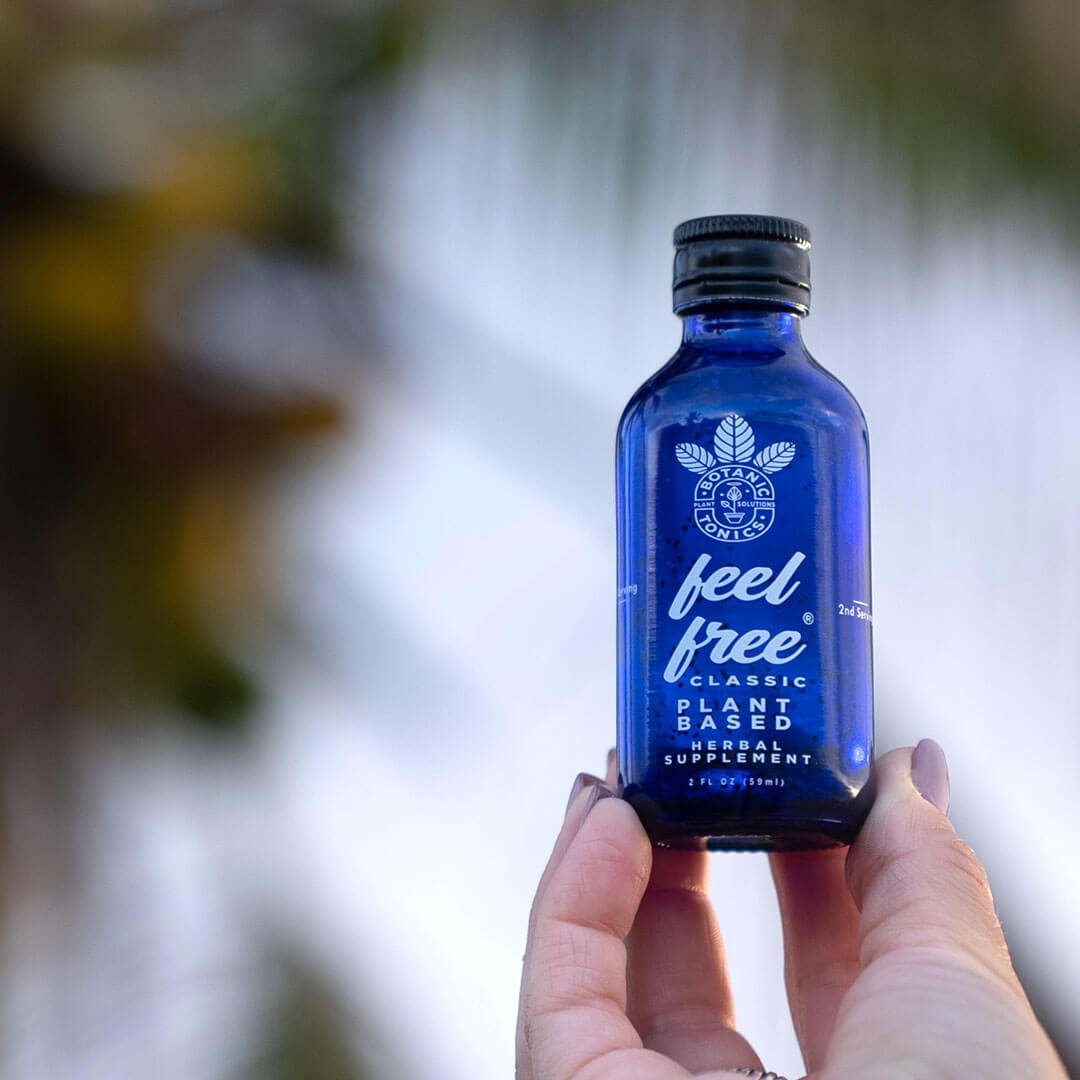 feel free classic wellness tonic - being held by a hand