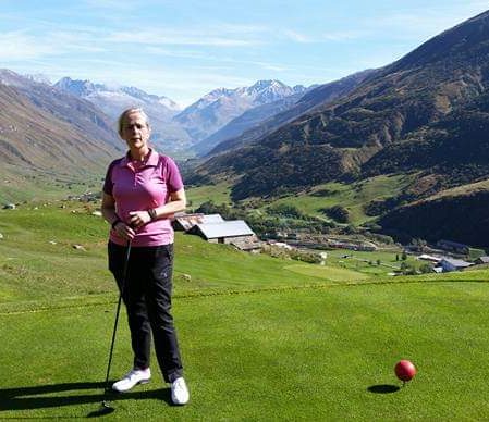 Fiona playing golf in a mountainscape