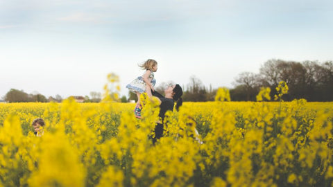Sarah playing in a rapeseed field