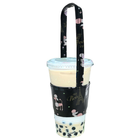 Black drink holder with poodle pattern holding a boba tea cup