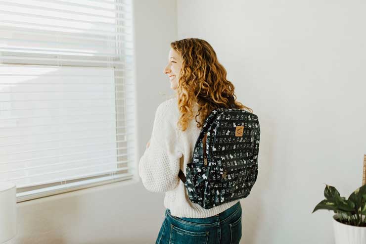 model wearing a large corgi backpack