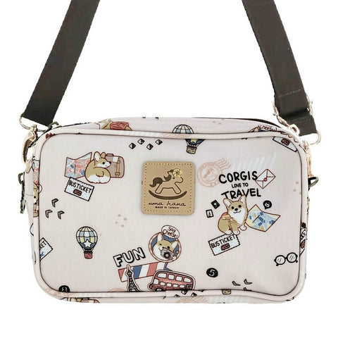 Pink crossbody bag with a traveling corgi themed pattern from Tworgis