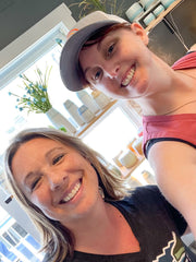 A photo of two Whidbey woman makers and artist: Erin of Elm Designs Candles and Briggs Shore of Briggs Shore Ceramics at the Coupeville Studio.