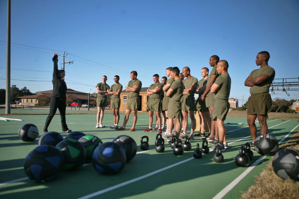 Military exercising with kettlebells