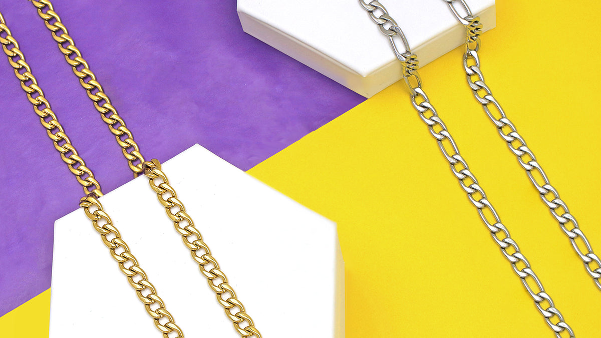 Yellow Gold Curb Chain and White Gold Figaro Chain on Purple and Yellow Background