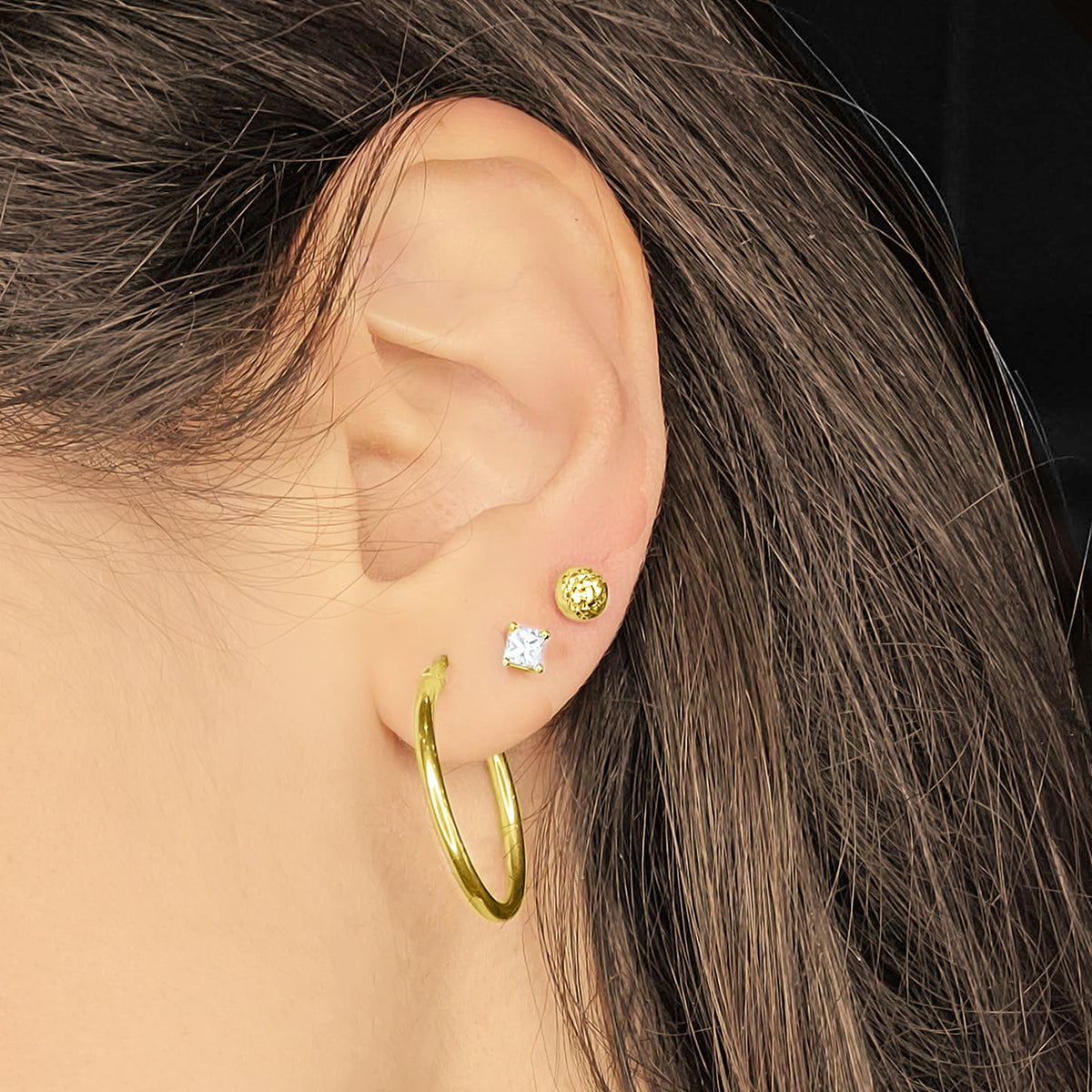 Gold Earrings and Diamond Princess Stud Worn by Woman