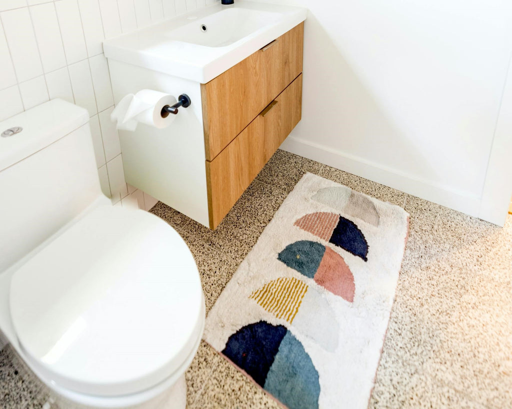 bathroom with colorful and abstract printed rug