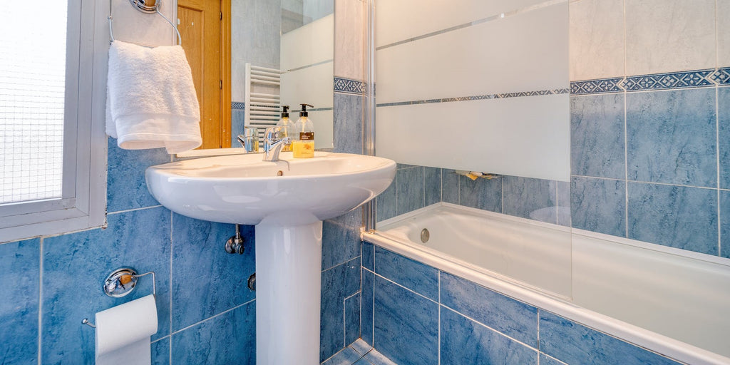 a bathroom with a bold, blue accent wall