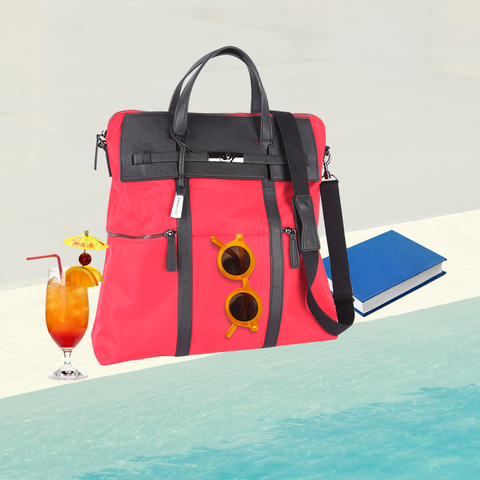 Red HIghline convertible backpack with a blue book, yellow sunglasses and tequila sunrise mocktail by the poolside