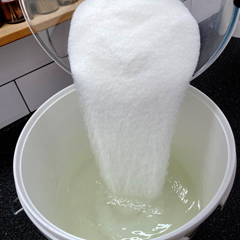 Pouring sugar into water