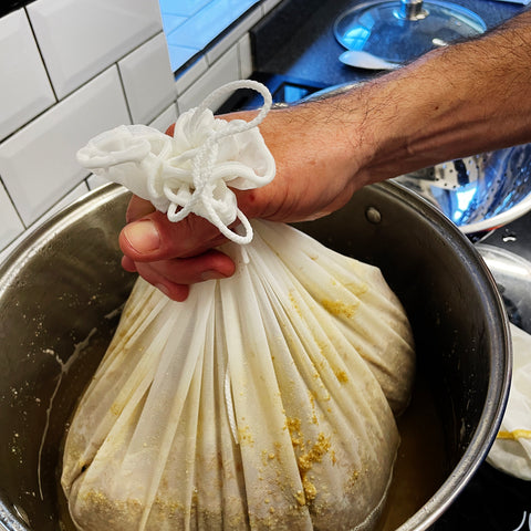 removing the bag of grain from the stockpot