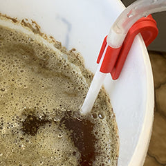 Siphon in bucket of beer