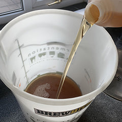 Pour the wine juice concentrate into the bucket