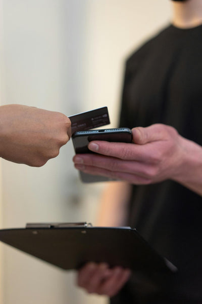 Person reading code from the card on the phone