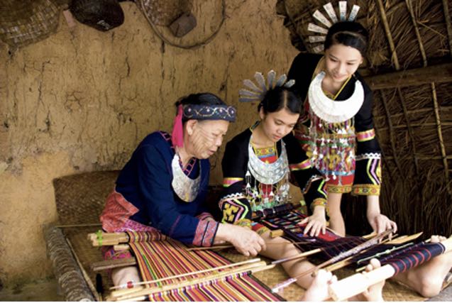 Young Miao girls learning weaving from an elder