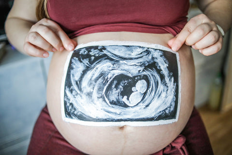 Artwork on a pregnant woman's belly for Halloween