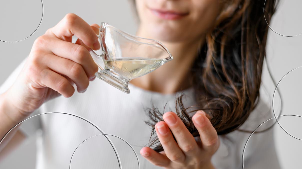 woman pouring coconut oil on her hair