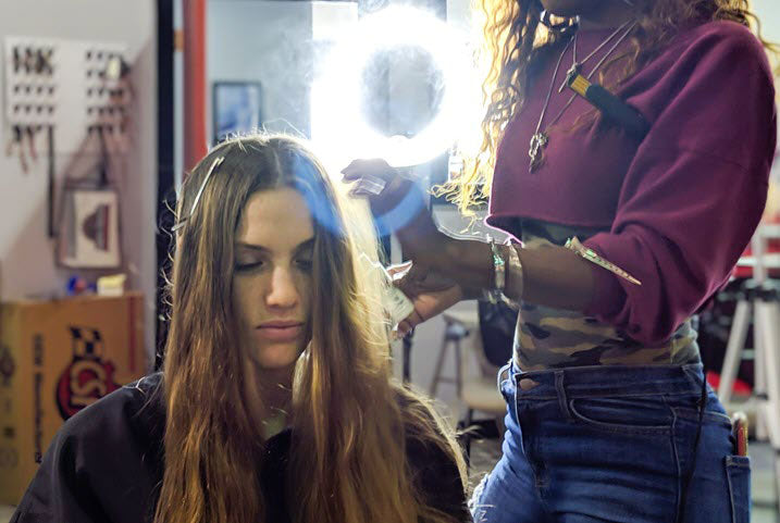 woman getting her hair done by a hairstylist