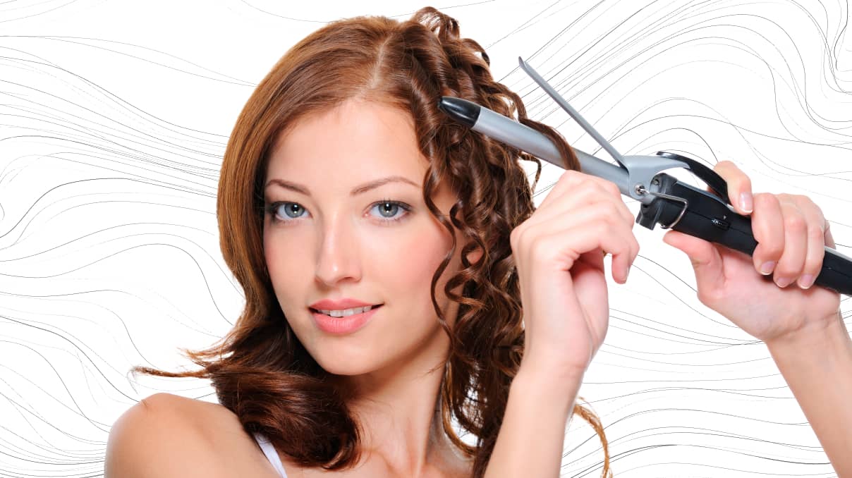 lady curling her hair with a curling iron