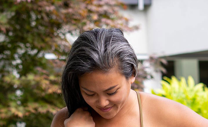 woman with curly graying hair at the park