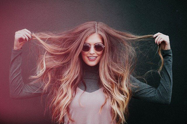 Woman pulling her hair extensions away from her face