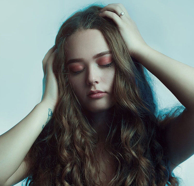 Beautiful young woman with curly long hair