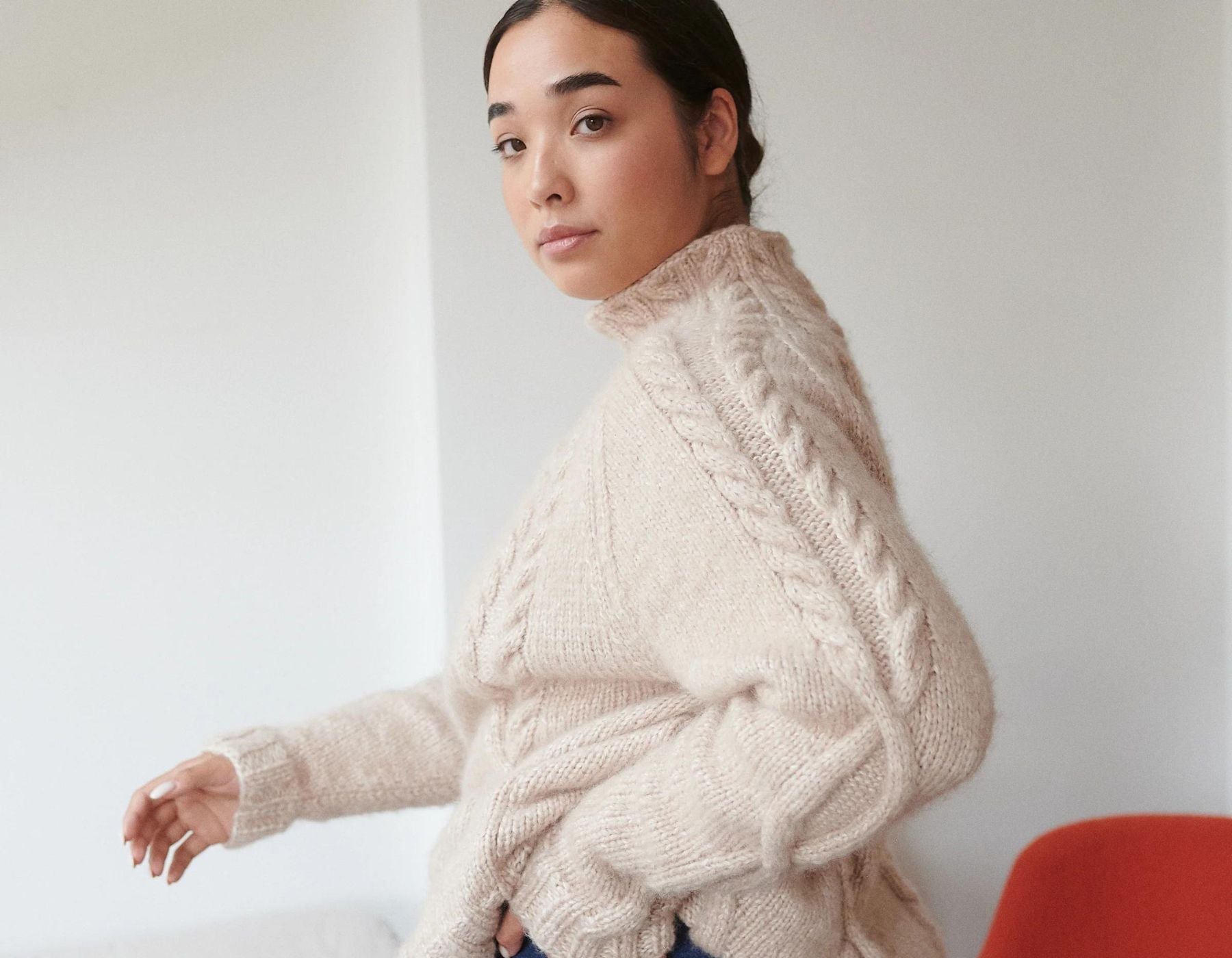 Woman wearing white The Knotty Ones knitted sweater