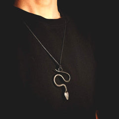 Model wearing a serpent pendant inspired by Scandinavian folklore and Norse mythology