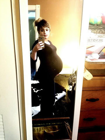 Aubrey taking a side angle selfie of pregnant belly 