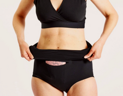 Model rolling down Nyssa FourthWear Postpartum Recovery underwear to show versatility for c-section or vaginal birth