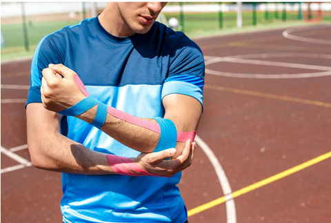 Athlete holding taped elbow