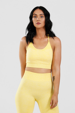 Girl wearing calypso seamless sports bra and shorts in yellow