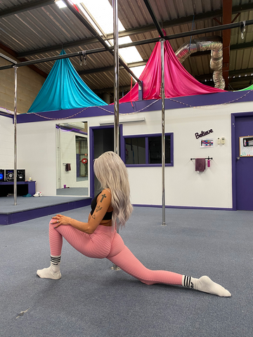 Girl stretching wearing pink adapt scrunch bum leggings