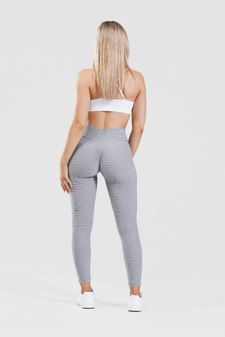 Girl wearing grey adapt scrunch bum leggings with white crop top back