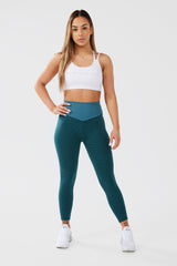 Girl posing hand on hip wearing luna seamless scrunch bum leggings and white crop top