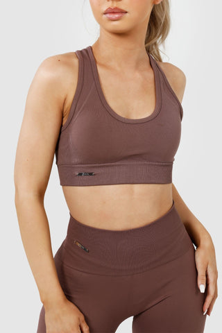 Close up girl wearing invictus seamless sports bra and leggings in mauve purple